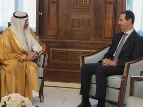 In this photo released by the official Facebook page of the Syrian Presidency, Syrian President Bashar Assad, right, meets with Saudi Arabia ambassador to Jordan Nayef al-Sadiri, in Damascus, Syria, Wednesday, May 11, 2023. Assad Wednesday received an invitation from Saudi Arabia to attend the upcoming Arab League summit at the oil-rich kingdom, the Syrian president's office said in a statement. the invitation days after the Arab League restored Syria's membership into the organization in Cairo, Egypt, on Sunday, after it was suspended in 2011 for the country's brutal crackdown on pro-democracy protesters.