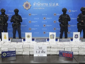 Police officers stand behind seized crystal methamphetamine during a news conference in Bangkok, Thailand, Monday, May 29, 2023. Law enforcement officials in Thailand said Monday they seized more than a ton of crystal methamphetamine in a southern province last week that they believed was bound for Australia.
