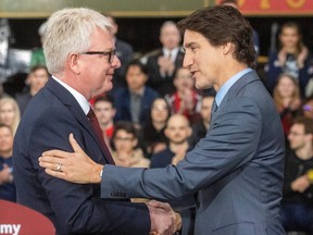 Prime Minister Justin Trudeau shaking hands with a guy his government just gave $13 billion.