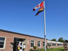 The Pride flag flies outside a school.