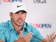 Brooks Koepka speaks to the media.