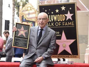 Alan Arkin holding his Walk of Fame sign