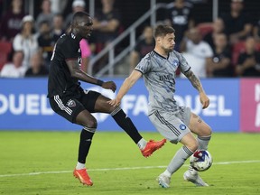 CF Montreal defender Gabriele Corbo, right, blocks a kick by D.C. United forward Christian Benteke during the second half of an MLS soccer match in Washington, Wednesday, May 31, 2023.