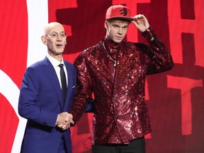 Gradey Dick poses for a photo with NBA Commissioner Adam Silver after being selected 13th overall by the Toronto Raptors during the NBA basketball draft, Thursday, June 22, 2023, in New York.