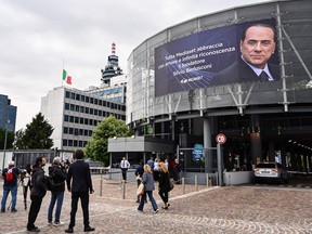 A picture taken on June 12, 2023 shows a giant banner bearing a portrait of late Italian former Prime Minister Silvio Berlusconi on the facade of the Mediaset headquarters in Cologno Monzese, Italy. Silvio Berlusconi, the former prime minister who reshaped Italy's political and cultural landscape has died aged 86 on June 12, 2023.