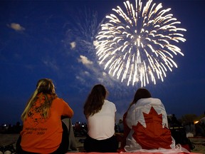 People watch fireworks fly over Toronto's Ashbridges Bay during Canada Day festivities in 2019.