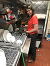Alberta Premier Danielle Smith washing dishes.
