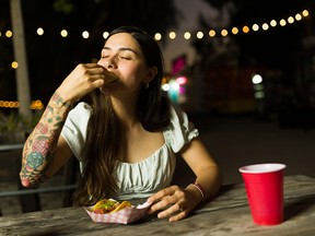 Person seated at a table eating fast food