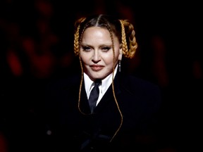 Madonna speaks onstage during the Grammy Awards.