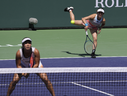 Miyu Kato, of Japan, right, serves behind her partner Aldila Sutjiadi, of Indonesia, as they play against Beatriz Haddad Maia, of Brazil, and Laura Siegemund, of Germany, in a doubles semifinal match at the BNP Paribas Open tennis tournament Friday, March 17, 2023, in Indian Wells, Calif.
