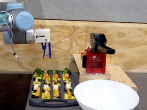 A robot 'chef' making salad with raw ingredients