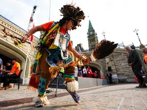 An Indigenous traditional dancer performs on Parliament Hill