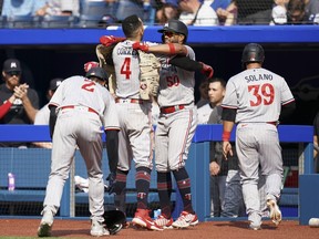 Minnesota Twins' Carlos Correa (4) celebrates with his teammates after hitting a grand slam against the Toronto Blue Jays during eighth inning American League MLB baseball action in Toronto on Saturday, June 10, 2023.