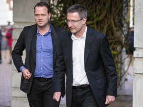 Bram ven der Kolk, letf, and Mathias Ortmann outside court after pleading guilty to their involvement in running the once wildly popular pirating website Megaupload in Auckland, New Zealand, Thursday, June 15, 2023.