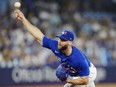 Toronto Blue Jays relief pitcher Anthony Bass (52) works against the Milwaukee Brewers during ninth inning MLB baseball action in Toronto on Wednesday, May 31, 2023. Blue Jays pitcher Anthony Bass said he's "in a better place moving forward" after speaking with Pride Toronto's executive director in the wake of his social media post that supported anti-2SLGBTQ+ boycotts.