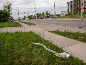 A destroyed street sign at the location where a family of five was hit by a driver, in London, Ont., Monday, June 7, 2021. Members of the Muslim community in London will host a vigil to mark the second anniversary of the worst mass killing in the city's history.