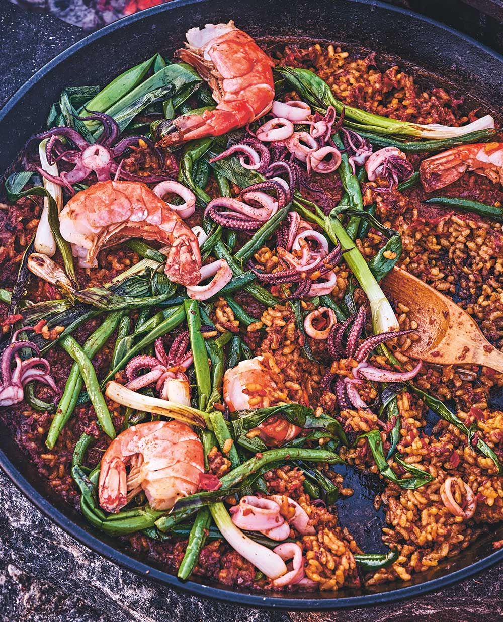 Paella cooking over a campfire