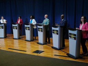 Josh Matlow, left, applauds a comment from Mitzie Hunter, centre left, as they are joined on stage by Olivia Chow, second left, Brad Bradford, centre right, Mark Saunders, second right, and Ana Bailao, right, at a Toronto Mayoral Candidates debate in Toronto, Wednesday, May 24, 2023.&ampnbsp;The seven leading candidates in Toronto's mayoral byelection are participating in another debate tonight, as the race to lead Canada's largest city enters its final stretch.