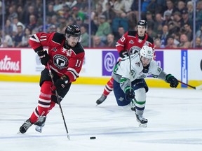Quebec Remparts' James Malatesta (11) skates with the puck past Seattle Thunderbirds' Kyle Crnkovic (61) during first period Memorial Cup hockey action in Kamloops, B.C., on Monday, May 29, 2023. The turning point that led to the Remparts' dominant season dates back just over a year. Managing director and head coach Patrick Roy pointed to last season's Quebec Major Junior Hockey League playoff semifinal loss to eventual league champion Shawinigan Cataractes on June 1.