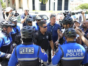 Miami Mayor Francis Suarez greets police outside the Wilkie D. Ferguson Jr. U.S. Courthouse, Tuesday, June 13, 2023, in Miami. Former President Donald Trump is making a federal court appearance on dozens of felony charges accusing him of illegally hoarding classified documents and thwarting the Justice Department's efforts to get the records back.