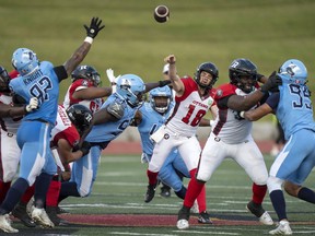 Ottawa Redblacks quarterback Dustin Crum (18) launches a pass from the pocket during first half CFL pre-season action against the Toronto Argonauts in Guelph, Ont. on Thursday, June 1, 2023.