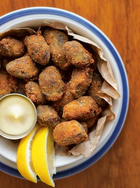 Fried oysters with lemon wedges and aioli