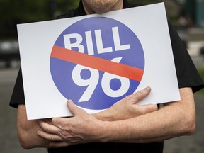 People take part in a protest against Bill 96 in Montreal, Thursday, May 26, 2022. Quebec's language law reform is continuing to draw criticism and legal challenges from the province's English community, a year after it was adopted, as more of its provisions come into effect.