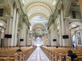People attend mass at Mary Queen of the World Cathedral in Montreal, Monday, Feb. 7, 2022. The ombudswoman of Montreal's Roman Catholic archdiocese says she's seen an improvement in the handling of complaints since raising concerns about it last year.&ampnbsp;THE CANADIAN PRESS/Graham Hughes