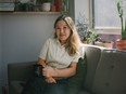 Author Hetty Lui McKinnon seated on a couch