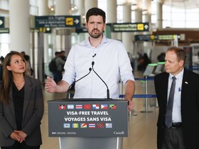 three people at a press conference in Winnipeg Airport