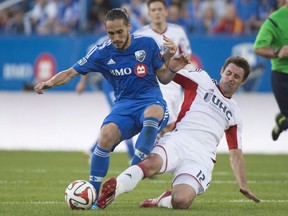 Montreal Impact's Issey Nakajima-Farran, left, battles for the ball against New England Revolution's Andy Dorman during first half MLS soccer action in Montreal on May 31, 2014. Football has already taken former Canadian international Issey Nakajima-Farran around the globe. The former Toronto FC, CF Montreal and Pacific FC midfielder has played club football in Australia, Cyprus, Denmark, Japan, Malaysia, Singapore and Spain as well as North America. Now newly retired, the 39-year-old Nakajima-Farran is working on his future aboard a boat in Barcelona. It's his floating home.