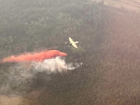 Airtankers work on a wildfire near Edson, Alta., in a Friday, June 9, 2023, handout photo. A town in northwestern Alberta is being evacuated due to an out-of-control wildfire. An evacuation order has been issued for the town of Edson and parts of Yellowhead County.