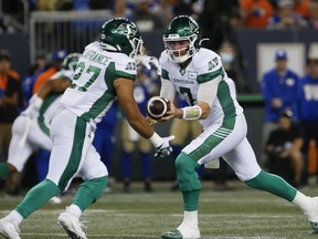 Saskatchewan Roughriders quarterback Cody Fajardo (7) hands off to Kienan LaFrance (27) during first half CFL action against the Winnipeg Blue Bombers in Winnipeg Friday, September 30, 2022.&ampnbsp;LaFrance&ampnbsp;was among 22 players released by the Saskatchewan Roughriders, the team announced Sunday.&ampnbsp;THE CANADIAN PRESS/John Woods