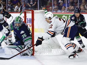 Seattle Thunderbirds goalie Thomas Milic, left, blocks a shot from Kamloops Blazers forward Daylan Kuefler during first period Memorial Cup hockey action in Kamloops, Wednesday, May 31, 2023.THE CANADIAN PRESS/Jeff McIntosh