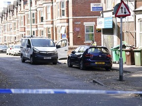 A white van is seen behind a police cordon on the corner of Maples Street and Bentinck Road after three people were killed in Nottingham city center, England early on Tuesday, June 13, 2023. A man was arrested on suspicion of murder in the English city of Nottingham Tuesday after three people were found dead and three others were hit and injured by a van in related early-morning incidents, police said.