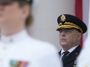 FILE - Chairman of the Joint Chiefs of Staff Gen. Mark Milley listens during an event at the Memorial Amphitheater of Arlington National Cemetery in Arlington, Va., on Memorial Day, on May 29, 2023. The chairman of the Joint Chiefs of Staff, Gen. Mark Milley, says the main battle tanks and fighter jets the U.S. has promised to Ukraine won't be ready in time for the imminent counteroffensive against Russia. Tank warfare will be key to Ukraine pushing Russia out of its territory, and the U.S. has begun training Ukrainian troops on M1A1 Abrams battle tank tactics.