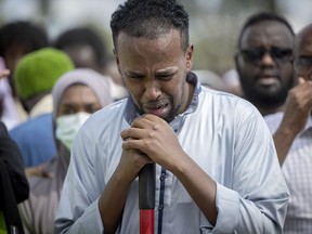 A man weeps before placing dirt into the burial site during the funeral of the five people killed in a car crash on Lake Street, at the Garden of Eden Islamic Cemetery in Burnsville, Minn., on Monday, June 19, 2023.