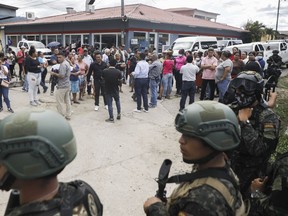 Police guard the entrance to the women's prison in Tamara, on the outskirts of Tegucigalpa, Honduras, Tuesday, June 20, 2023. A riot at the women's prison northwest of the Honduran capital has left at least 41 inmates dead, most of them burned to death, a Honduran police official said.
