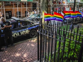 FILE - Pride flags, a symbol celebrating the LGBTQ+ community, decorate the fence at the Stonewall National Monument with U.S. Park police present, Tuesday, June 13, 2023, in New York. Dozens of LGBTQ+ Pride flags were damaged and ripped down at the monument over the weekend, the third such bout of vandalism during Pride Month at the LGBTQ+ landmark, police said.