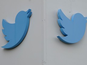 FILE - Twitter logos hang outside the company's offices in San Francisco, Monday, Dec. 19, 2022. Ella Irwin, a top Twitter executive responsible for safety and content moderation, has left the company. Her departure came after owner Elon Musk publicly complained about the platform's handling of posts about transgender topics.