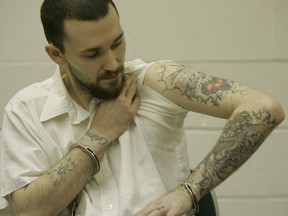 FILE - Inmate Michael Tisius, sentenced to death in the killing of two jail officers, shows his tattoos during an interview at Potosi Correctional Center, Missouri's maximum security prison where condemned men live in the general prison population in Mineral Point, Mo., on Jan. 11, 2007. A federal judge on Wednesday, May 31, 2023, halted next week's scheduled execution of Tisius, a man convicted of killing two Missouri jailers, amid questions about the literacy of a juror in the case.
