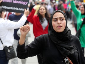 A hijabi woman at an anti-Pride protest