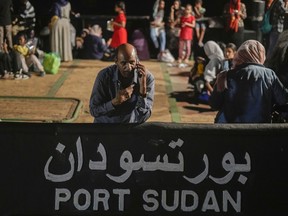 A Sudanese evacuee waits at Port Sudan before boarding a Saudi military ship to Jeddah port, on May 3, 2023. A doctor trying to co-ordinate basic medical services after Sudan's rapid descent into chaos says the government and militias are hampering lifesaving aid and leaving children dying, as Canada crafts its response to the crisis.