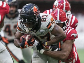 BC Lions' Terry Williams (left) is brought down by Calgary Stampeders' Kelon Thomas during the first half of CFL pre-season football action in Vancouver, B.C., Thursday, June 1, 2023.