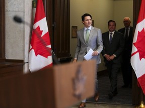 Prime Minister Justin Trudeau, Minister of Public Safety Marco Mendicino (centre) and Minister of Emergency Preparedness Bill Blair arrive to hold a press conference on Parliament Hill in Ottawa on Tuesday, May 23, 2023. The federal government is proclaiming a National Day Against Gun Violence, to be held annually on the first Friday of June.