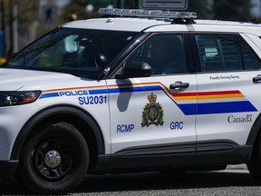 A Surrey RCMP officer drives a police vehicle in Surrey, B.C., on Friday, April 28, 2023. Surrey Mounties say a person has been taken to hospital with serious injuries after a plane caught fire in a field in the Metro Vancouver community of Surrey.
