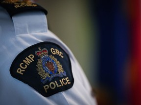 An RCMP patch is seen on the shoulder of a Surrey RCMP Officer in Charge during a news conference in Surrey, B.C., on Friday, April 28, 2023. Four people have been found dead in a home in British Columbia's northwest in what police is calling a homicide.