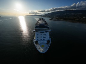 The Norwegian Cruise Line ship Norwegian Bliss passes under the Lions Gate Bridge upon arrival in Vancouver, on Thursday, April 13, 2023. A possible strike by British Columbia port workers will not disrupt cruise ships docked in Vancouver, Prince Rupert or Vancouver Island, employers say.