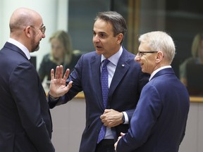 European Council President Charles Michel, left, speaks with Greece's Prime Minister Kyriakos Mitsotakis, center, and Bulgaria's Prime Minister Nikolai Denkov during a round table meeting at the European Council building in Brussels, Friday, June 30, 2023. European Union leaders on Friday resumed migration talks for a second day as Poland and Hungary continued to block progress after they were outvoted earlier this month on a plan to share out refugees arriving in Europe among the 27 member countries.