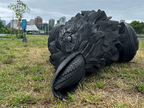 Ottawa's latest foray into public art: A dead crow statue made of old tires at the side of a road - National Post
